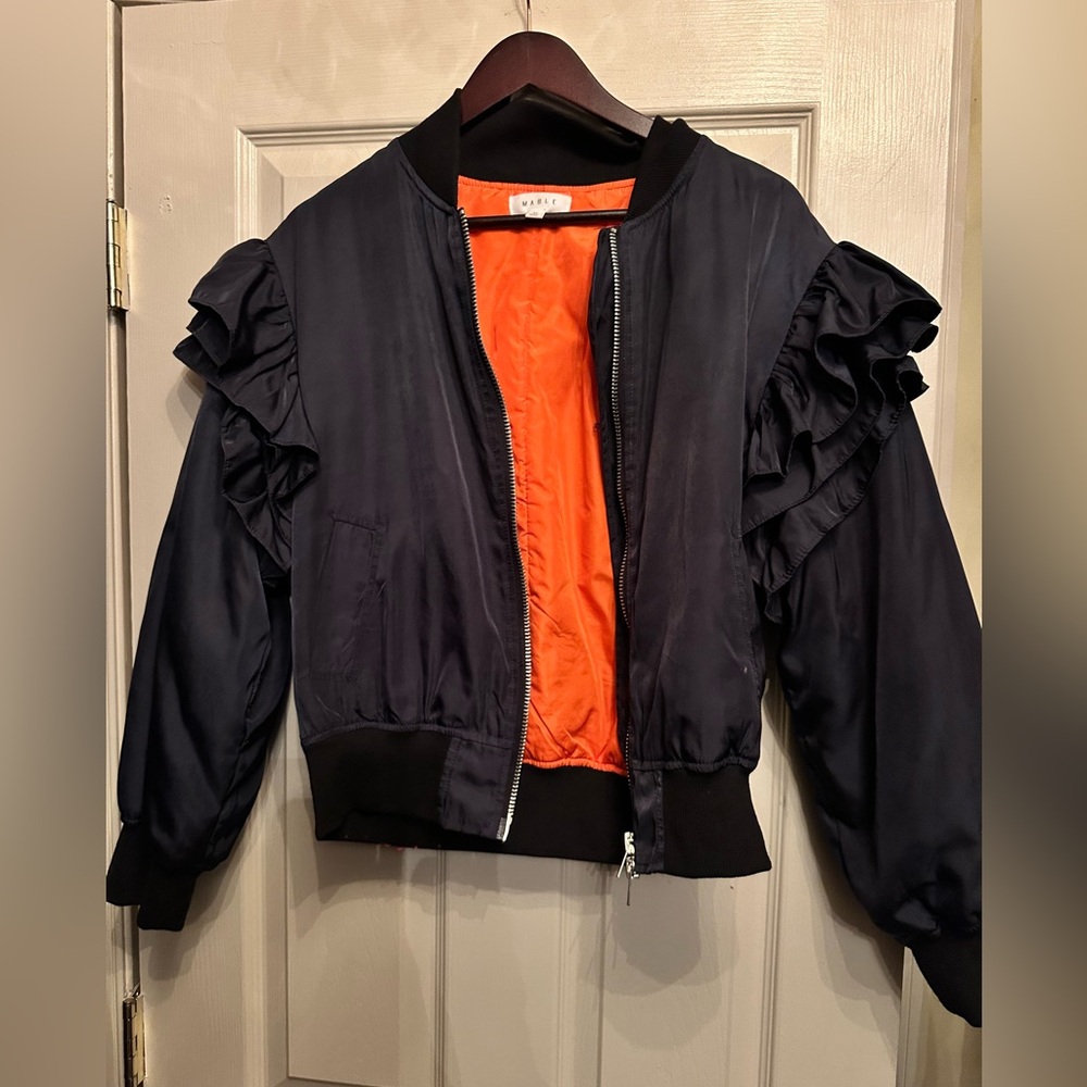 Blue zipper jacket, orange lining. Ruffled sleeves